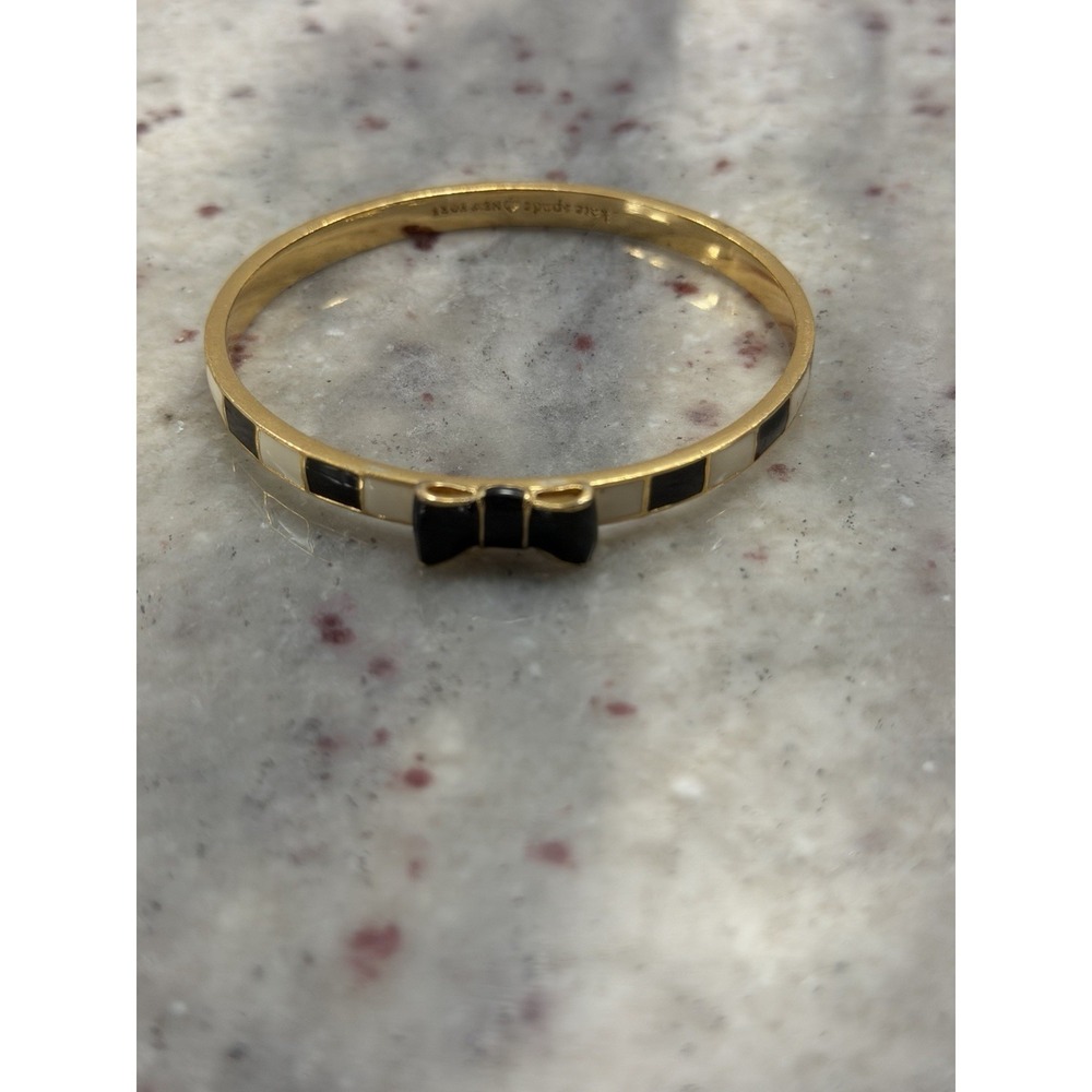 Kate Spade Take A Bow Black, White, and Gold Gold Colored Bracelet